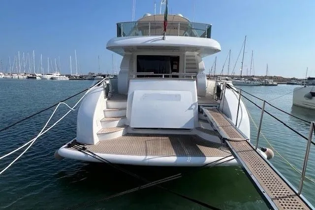  Yacht Photos Pics Luxury Maiora 24 S yacht, 2004 model, docked in a marina with clear blue skies.