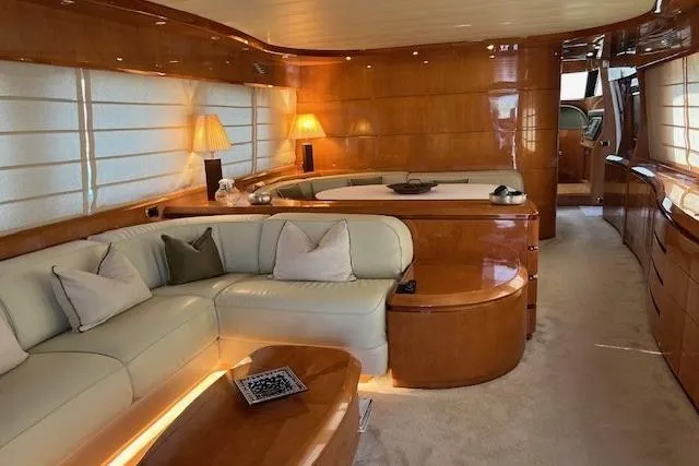  Yacht Photos Pics Luxurious interior of a 2004 Maiora 24 S yacht with elegant wood finishes and plush seating.