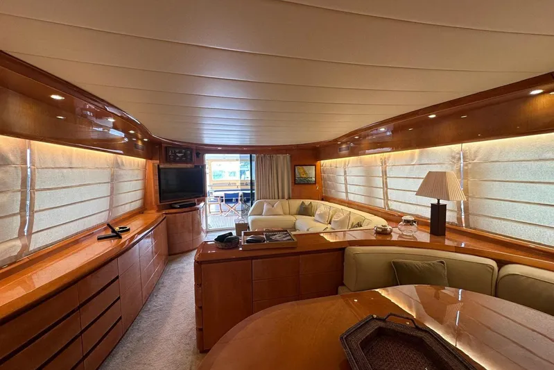  Yacht Photos Pics Luxurious interior of a 2004 Maiora 24 S yacht with elegant wood finishes and cozy seating.