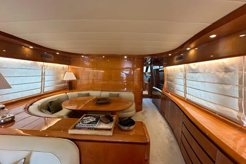  Yacht Photos Pics Luxurious interior of a 2004 Maiora 24 S yacht with elegant wood finishes and plush seating.