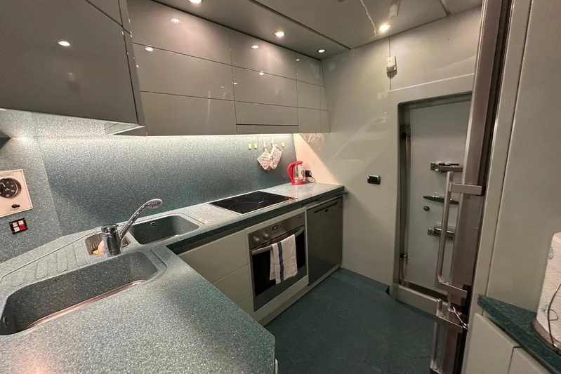  Yacht Photos Pics Modern kitchen in a 2004 Maiora 24 S yacht with sleek cabinetry and appliances.