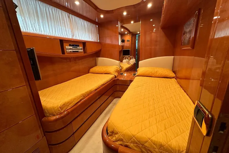 Yacht Photos Pics Luxurious twin cabin interior of 2004 Maiora 24 S yacht with warm wood finishes.