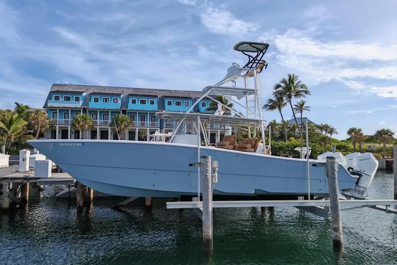  Yacht Photos Pics 2025 Freeman 42 boat docked near tropical resort with palm trees and blue sky.