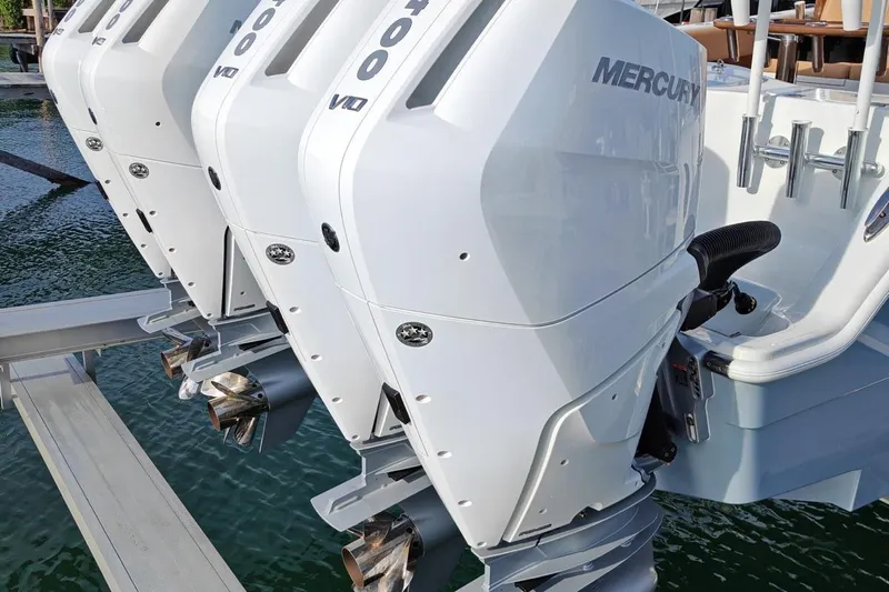  Yacht Photos Pics Triple Mercury outboard engines on a 2025 Freeman 42 boat, docked on water.