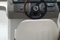 Interior of a 2003 Cobalt 200 boat with steering wheel and dashboard controls.