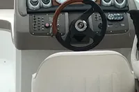 Steering wheel and dashboard of a 2003 Cobalt 200 boat.