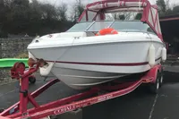 2003 Cobalt 200 boat on red trailer with canopy and life preserver.