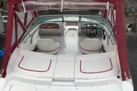 2003 Cobalt 200 boat interior with white seating and red trim under a maroon canopy.