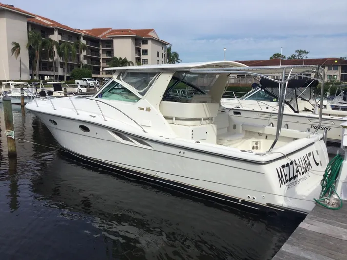  Yacht Photos Pics 1998 Tiara Yachts 3500 Open docked at marina, white exterior, calm water, residential backdrop.