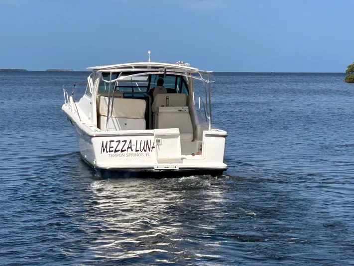  Yacht Photos Pics 1998 Tiara Yachts 3500 Open boat on water, rear view, clear sky.