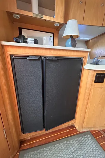  Yacht Photos Pics 1998 Tiara Yachts 3500 Open interior with fridge, microwave, and lamp.