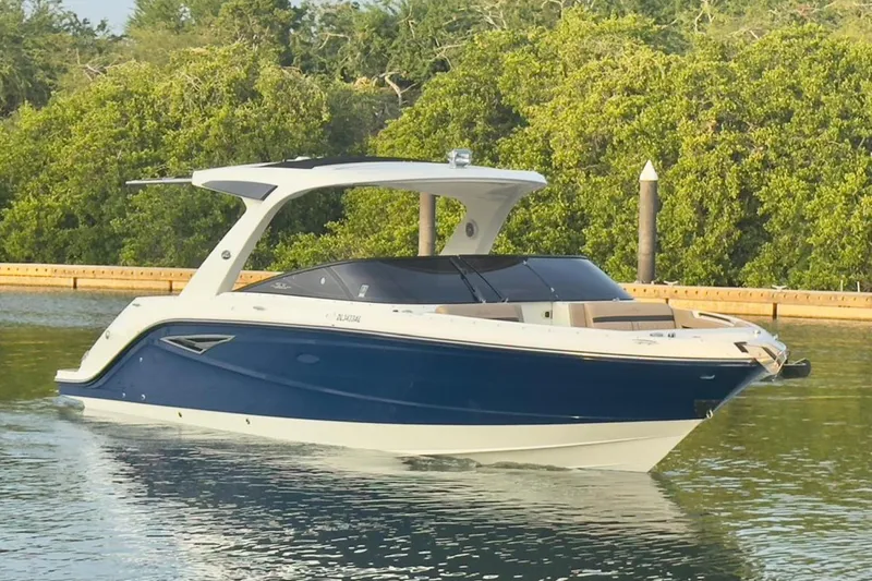 2017 Sea Ray 310 Slx @ Puerto Vallarta "bella" Yacht Photos Pics 2017 Sea Ray 310 SLX boat cruising on calm water, surrounded by lush greenery.