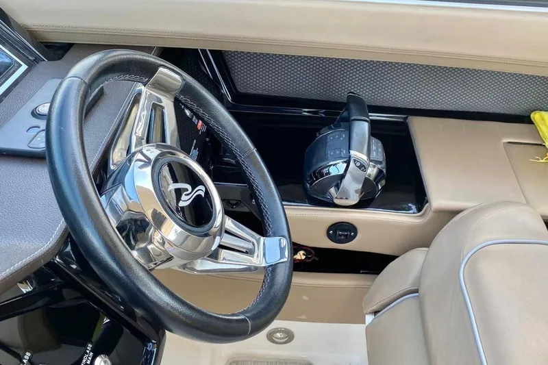 2017 Sea Ray 310 Slx @ Puerto Vallarta "bella" Yacht Photos Pics Steering wheel and controls of a 2017 Sea Ray 310 SLX boat interior.