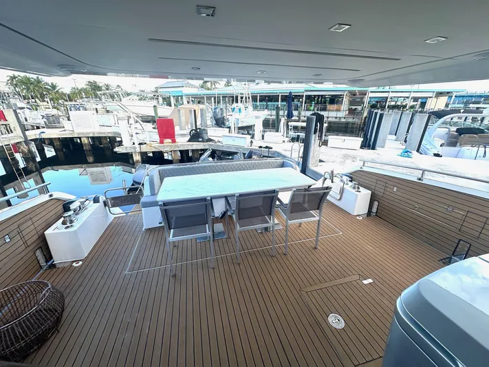 American Dream Yacht Photos Pics Luxury yacht deck with dining area, Schaefer 660, 2023 model, docked at marina.
