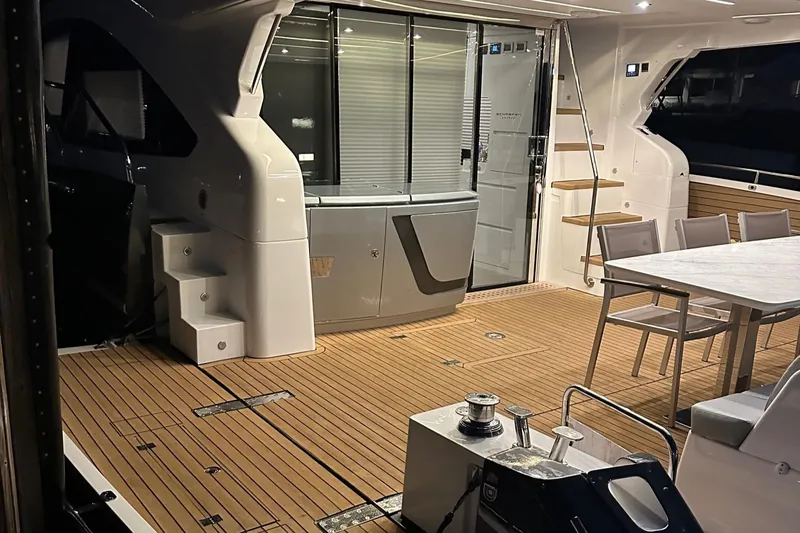 American Dream Yacht Photos Pics Luxurious 2023 Schaefer 660 yacht interior with modern seating and wooden flooring.