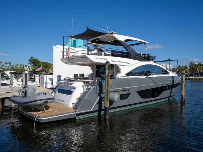 American Dream Yacht Photos Pics 2023 Schaefer 660 yacht docked in a marina under clear blue skies.