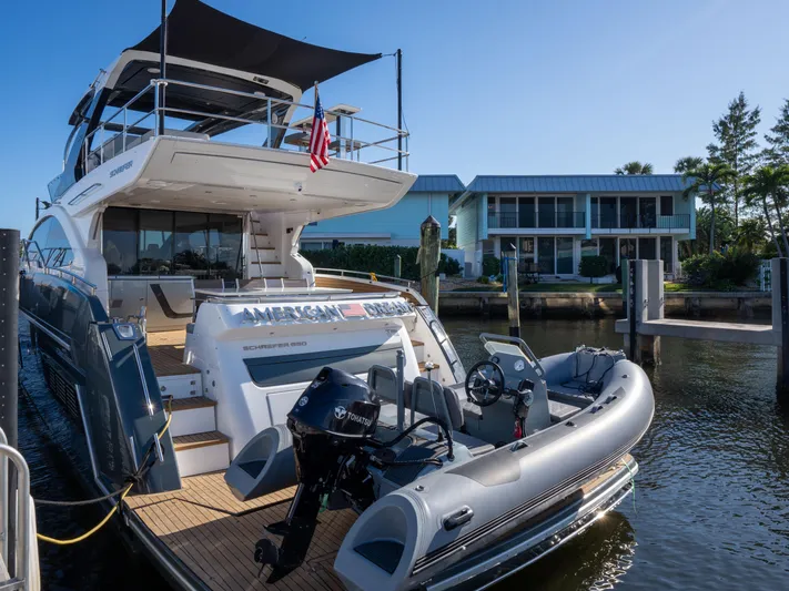 American Dream Yacht Photos Pics Luxury Schaefer 660 yacht docked, featuring a small tender boat, 2023 model.