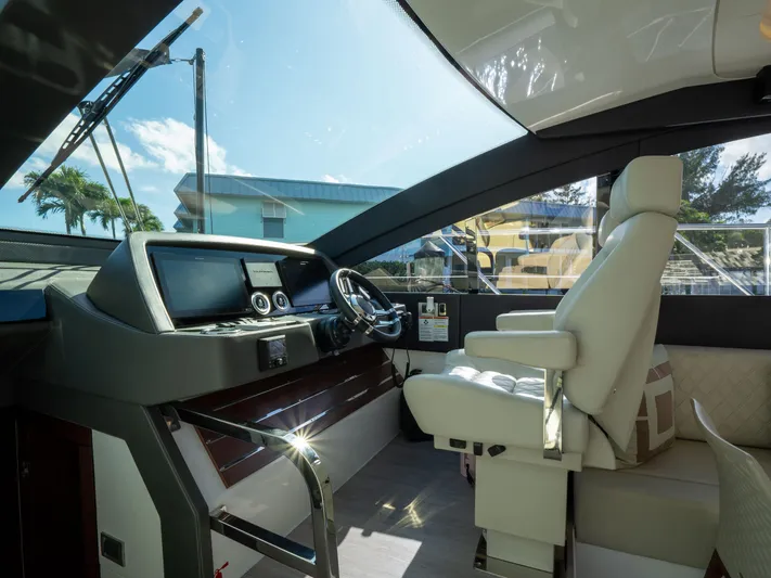 American Dream Yacht Photos Pics Luxurious interior of 2023 Schaefer 660 yacht, featuring modern helm and comfortable seating.