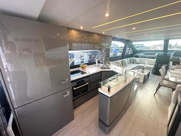 American Dream Yacht Photos Pics Luxurious interior of 2023 Schaefer 660 yacht with modern kitchen and seating area.