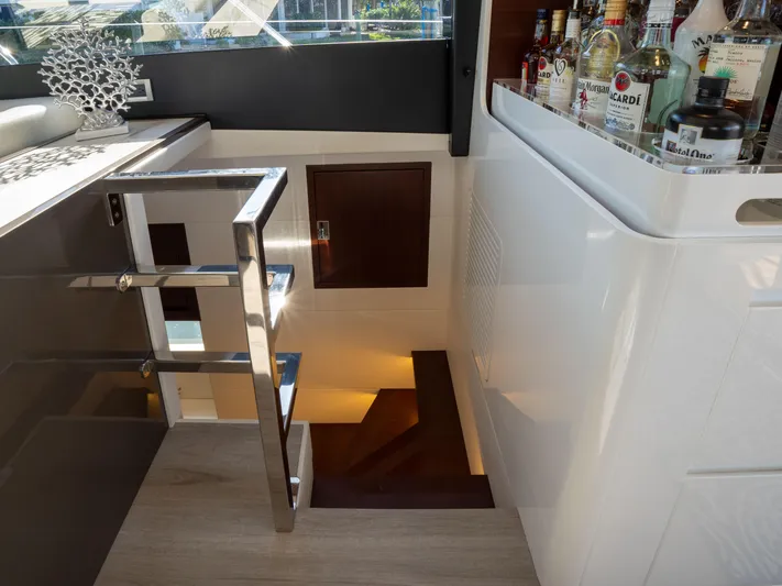 American Dream Yacht Photos Pics Interior of 2023 Schaefer 660 yacht with stairs and a stocked bar area.