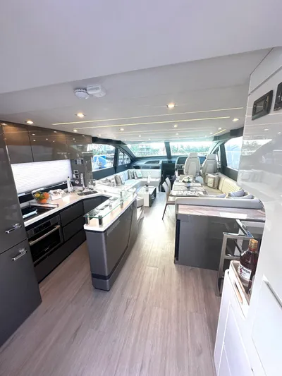 American Dream Yacht Photos Pics Luxurious interior of 2023 Schaefer 660 yacht with modern kitchen and seating area.