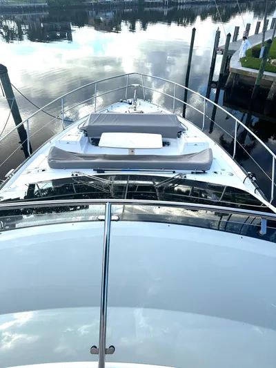 American Dream Yacht Photos Pics 2023 Schaefer 660 yacht on calm water, docked at a marina.