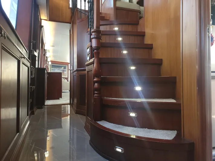  Yacht Photos Pics Luxurious wooden staircase inside 2006 Cheoy Lee Motor Yacht Bravo Series, featuring elegant lighting.