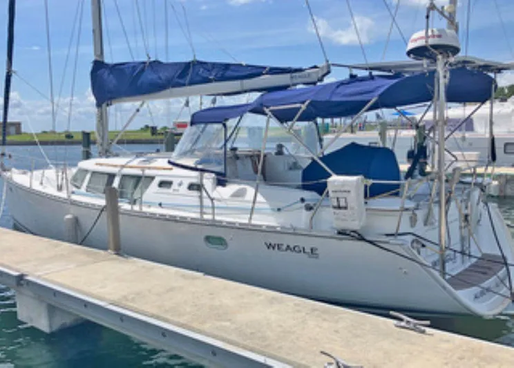 Weagle Yacht Photos Pics 2002 Jeanneau 43DS sailboat docked with blue covers and clear skies.