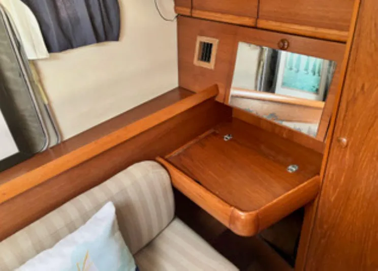 Weagle Yacht Photos Pics Interior of 2002 Jeanneau 43DS yacht with wooden desk and mirror.