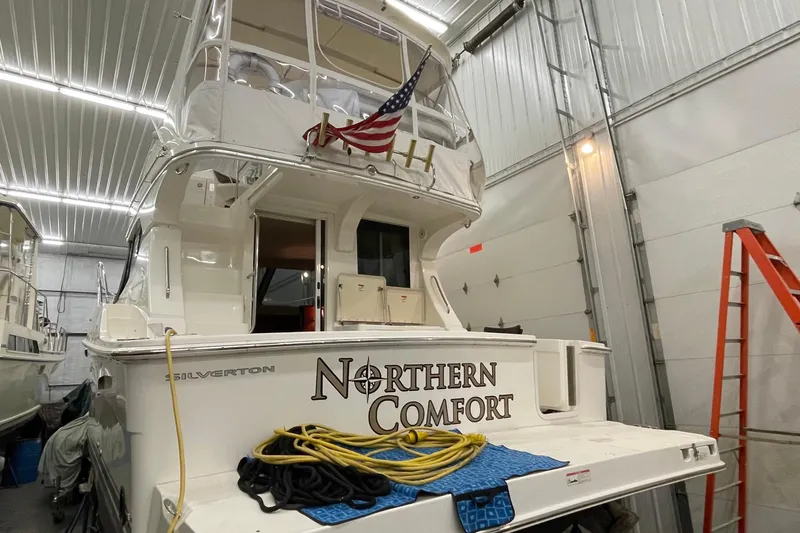 Northern Comfort Yacht Photos Pics 2005 Silverton 34 Convertible yacht "Northern Comfort" in indoor storage with American flag.