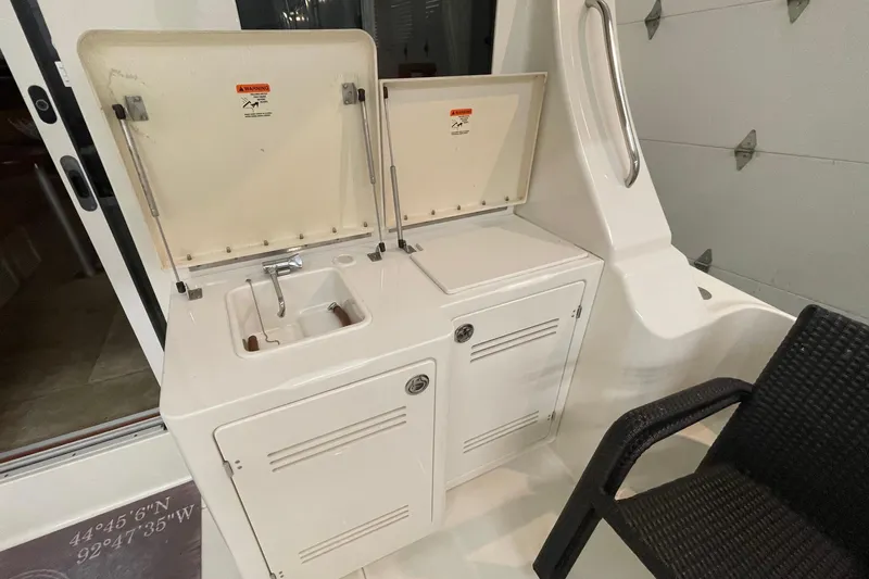 Northern Comfort Yacht Photos Pics 2005 Silverton 34 Convertible yacht interior with sink and storage compartments.