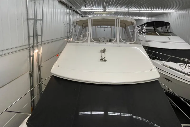 Northern Comfort Yacht Photos Pics 2005 Silverton 34 Convertible yacht in indoor storage, showcasing sleek design and spacious deck.