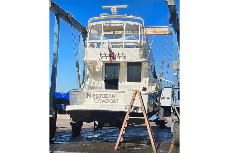 Northern Comfort Yacht Photos Pics 2005 Silverton 34 Convertible yacht, "Northern Comfort," in dry dock with blue sky background.