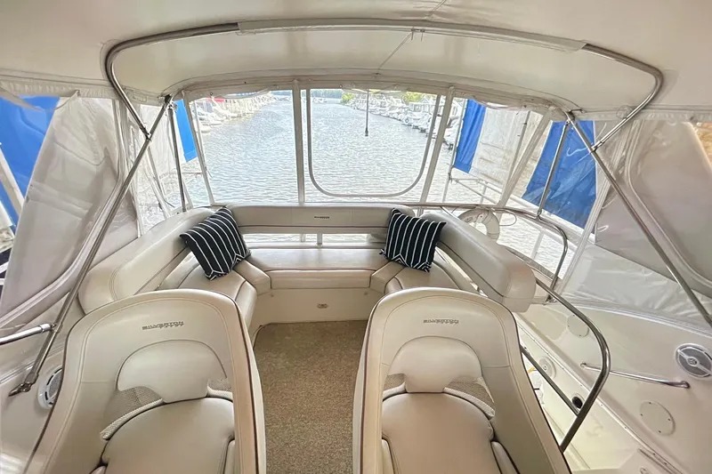 Northern Comfort Yacht Photos Pics Interior view of 2005 Silverton 34 Convertible yacht with plush seating and water backdrop.