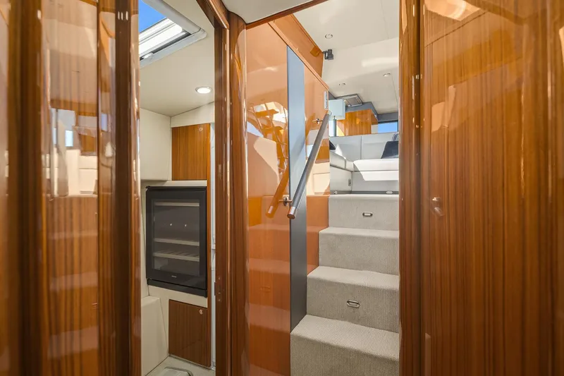 Blue Sky *name Reserved Yacht Photos Pics Interior of 2016 Maritimo M50 yacht with wooden finishes and carpeted stairs.