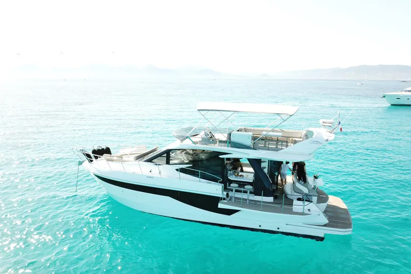  Yacht Photos Pics 2021 Galeon 460 Fly yacht on clear turquoise water, side view.
