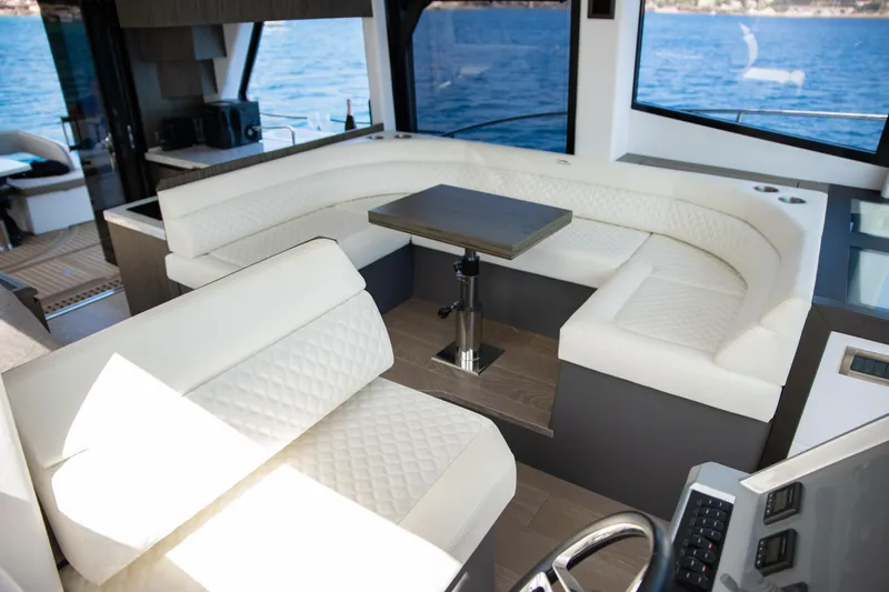  Yacht Photos Pics Luxurious interior of 2021 Galeon 460 Fly yacht with white seating and ocean view.