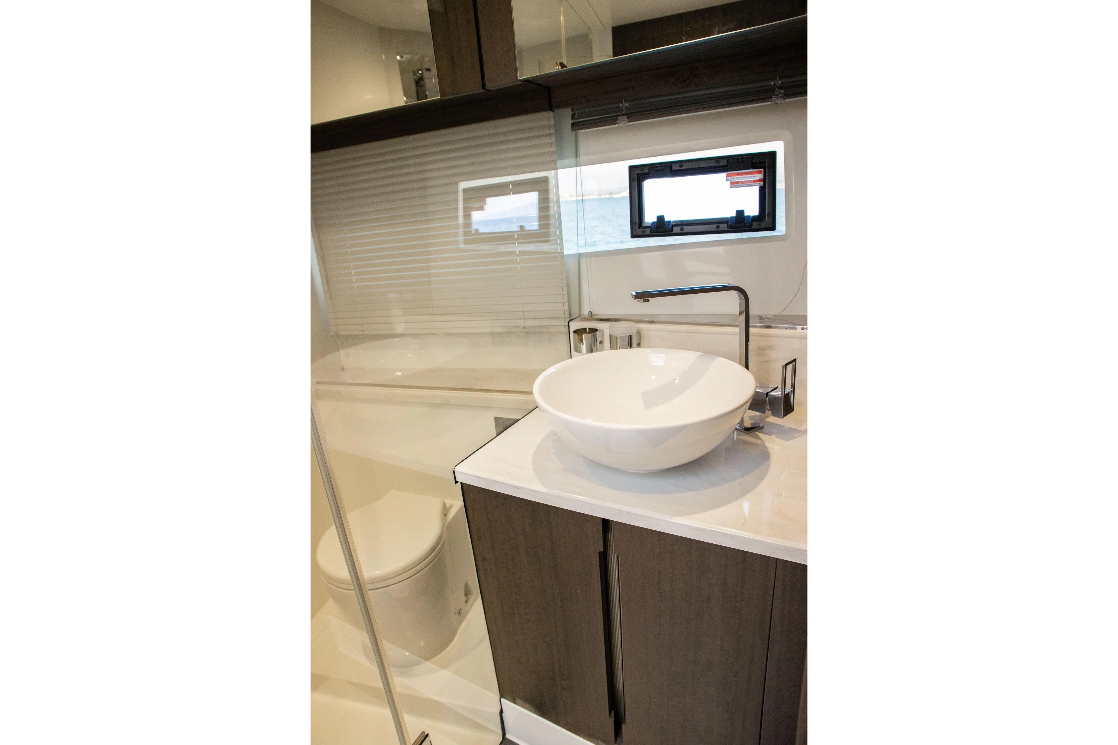  Yacht Photos Pics Luxurious bathroom in 2021 Galeon 460 Fly yacht with modern sink and window view.