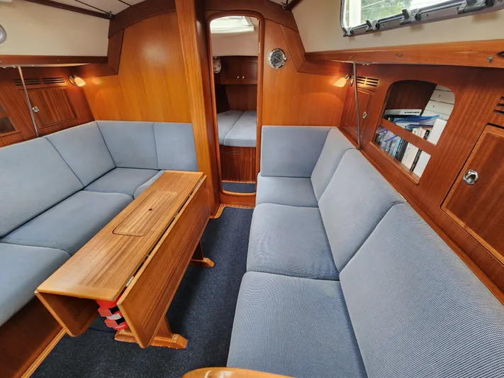 Ceres Yacht Photos Pics Interior of 2016 Hallberg-Rassy 342 yacht with wooden finish and blue upholstery.