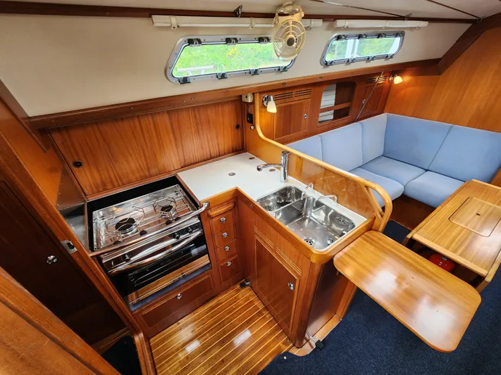 Ceres Yacht Photos Pics Interior of 2016 Hallberg-Rassy 342 yacht with kitchen and seating area.