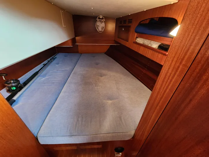 Ceres Yacht Photos Pics Cozy cabin interior of 2016 Hallberg-Rassy 342 sailboat with wooden finish and blue mattress.