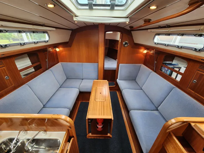 Ceres Yacht Photos Pics Interior of 2016 Hallberg-Rassy 342 yacht with cozy seating and wooden finishes.