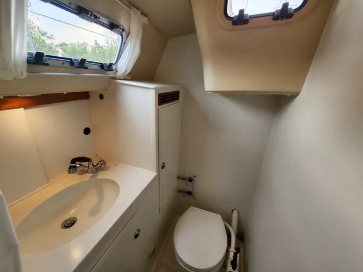 Ceres Yacht Photos Pics 2016 Hallberg-Rassy 342 yacht bathroom with sink, toilet, and window.