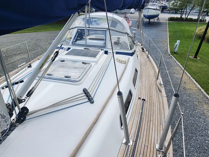 Ceres Yacht Photos Pics 2016 Hallberg-Rassy 342 sailboat with teak deck and blue canvas, docked in a marina.