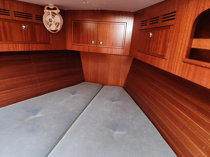 Ceres Yacht Photos Pics Interior cabin of 2016 Hallberg-Rassy 342 yacht with wooden finish and blue cushions.