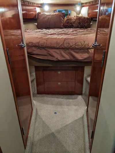  Yacht Photos Pics Luxurious bedroom interior of 2006 Sea Ray 44 Sundancer yacht with wooden cabinetry.