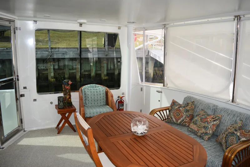 Wandra Yacht Photos Pics Novatec Islander 60 yacht interior, featuring a cozy seating area with wooden table, 2008 model.