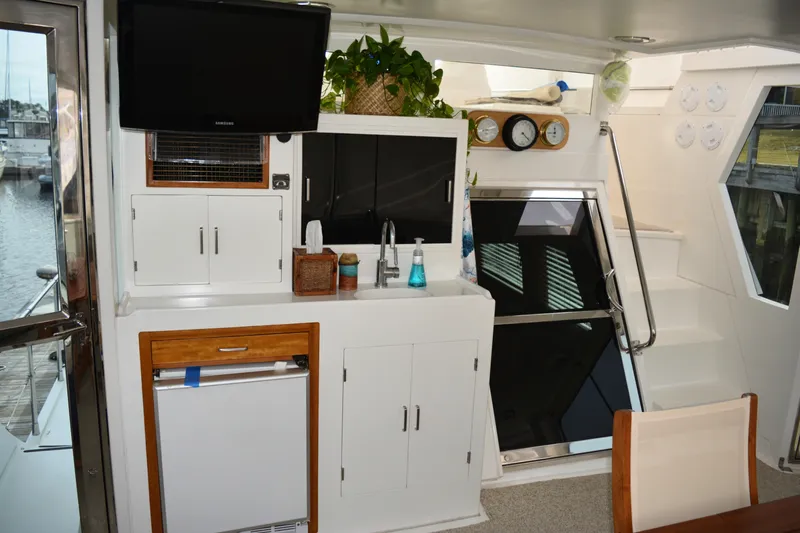 Wandra Yacht Photos Pics Interior of 2008 Novatec Islander 60 yacht with kitchenette, TV, and stairs.