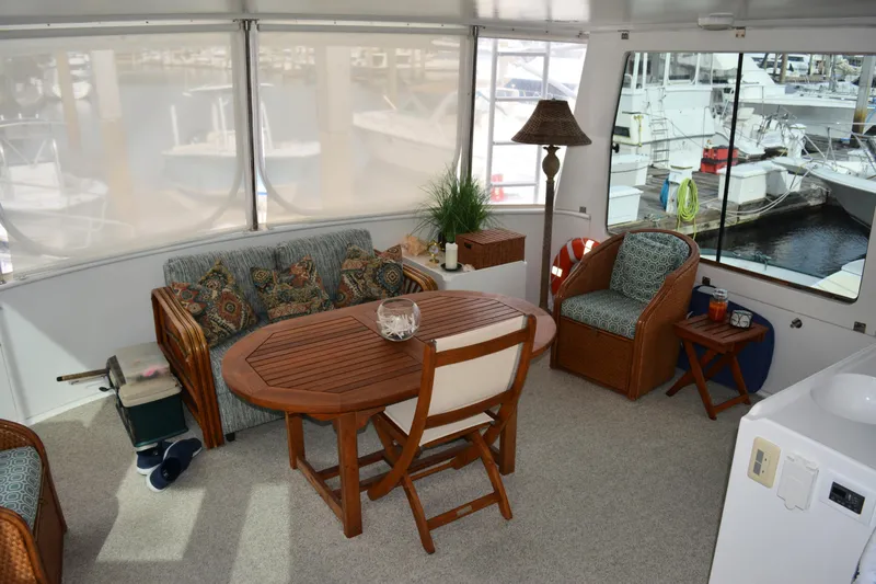 Wandra Yacht Photos Pics Cozy interior of 2008 Novatec Islander 60 yacht with seating and table.