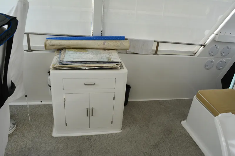 Wandra Yacht Photos Pics Interior of 2008 Novatec Islander 60 yacht with navigation maps on cabinet.